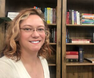 Sarah L. Vigue headshot with books